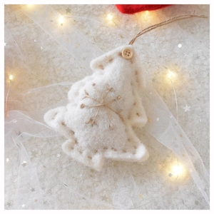 Detail of wool felt white Christmas tree ornament with snowflake embroidery and rope