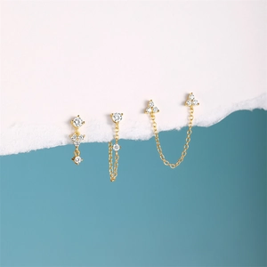 Detail of four gold S925 silver flower earrings with opal and diamond accents