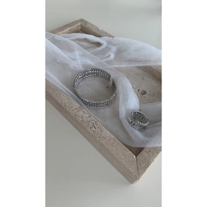 Detailed macro shot of silver multilayer cubic zirconia cuff bracelet and matching ring