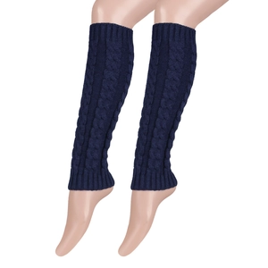 Detail of dark blue cable knit leg warmers showing thick braided texture and ribbed cuffs