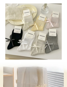 Detailed display of colorful combed cotton crew socks with sweet ribbon bow designs