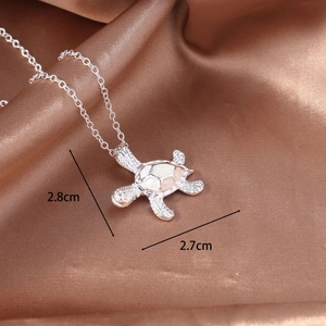 Macro view of silver turtle pendant with opal shell and 2.8cm x 2.7cm size scale