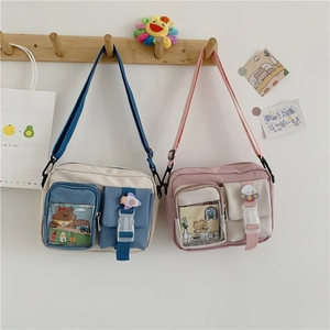 Detail of canvas crossbody bags featuring cartoon bears and multi-pocket structure