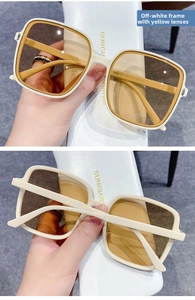 Detail view of cream square sunglasses with yellow lenses and white protective case