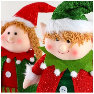 Close-up of plush Christmas elf dolls featuring festive red and green sequins and knit texture
