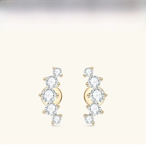 Detailed view of curved gold studs featuring five graduated round-cut moissanite stones