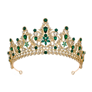 Close-up of golden crown with sparkling green rhinestones and intricate metal detail