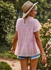 Detail of pink floral print top showing ruffled sleeves and button back closure