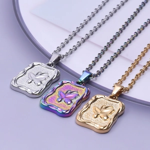 Detailed view of three butterfly rectangle pendants in silver, gold, and rainbow finishes