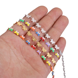 Detail of colorful enamel butterfly chains in gold and silver finishes for DIY jewelry
