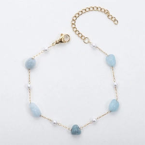Detail of 18K gold plated bracelet with light blue irregular stones and white pearls