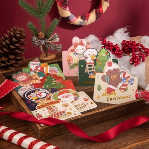 Festive Christmas greeting cards set with gold foil illustrations on a wooden tray