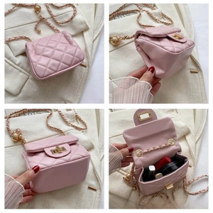 Detail view of pink quilted mini bag with gold chain strap and turn-lock closure