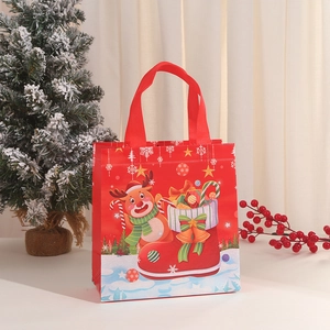 Christmas non-woven gift bag with reindeer print and red handles for holiday parties