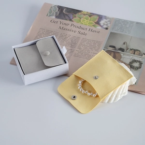 Gray velvet jewelry box and yellow velvet envelope pouch for rings and pearl bracelets
