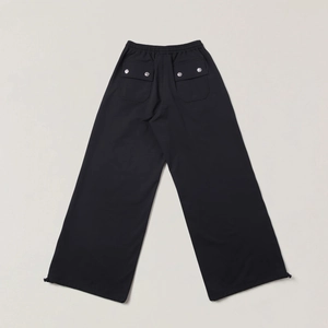 Detail of black wide-leg cargo pants featuring large back pockets and adjustable drawstrings