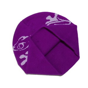 Close-up of deep purple knit beanie featuring abstract jacquard patterns and warm texture