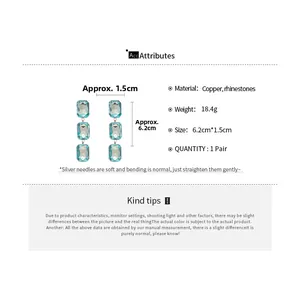 Detail showing blue rectangle rhinestone earrings with silver needles and size specs