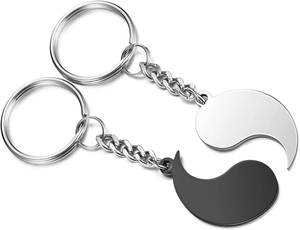 Close-up of black and silver stainless steel sun moon puzzle keychains with magnetic fit