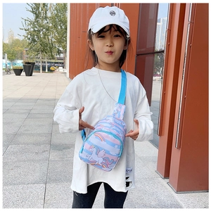 Outdoor street view of a child wearing the colorful unicorn and rainbow crossbody chest bag