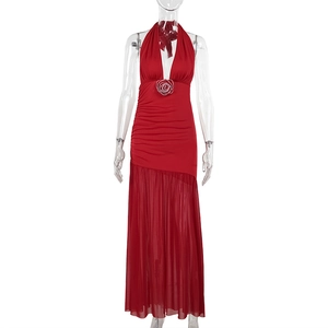 Detail view of red halter dress featuring a 3D rose ornament and pleated sheer skirt