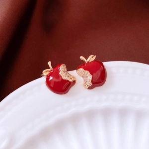 Detail of red apple stud earrings with gold plating and sparkling crystal accents