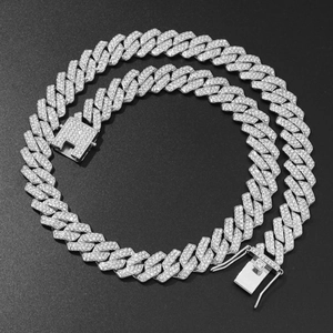 Macro shot of silver Cuban link chain with double rows of sparkling rhinestones on black