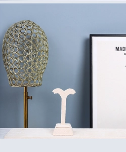 Detail of beige velvet jewelry stand and gold metal hollow wig rack display set