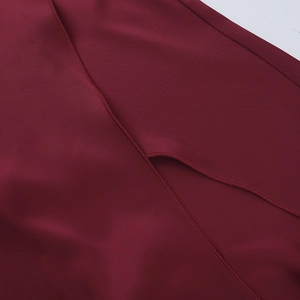 Detail of split hem stitching and fabric texture on a wine red sexy evening dress
