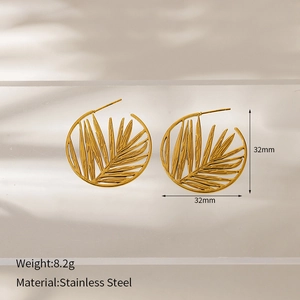 Detail view of 32mm golden hollow palm leaf hoop earrings in stainless steel