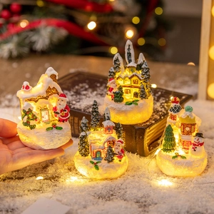 Miniature glowing Christmas resin gingerbread house with Santa and snowman scene