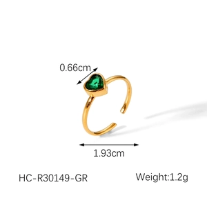Detail of 18k gold open ring featuring a green heart-shaped gemstone setting
