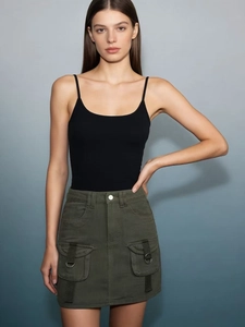 Detail of dark olive green cargo mini skirt with large pockets and high waist design