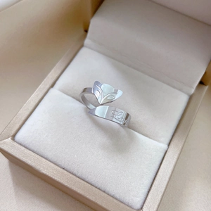 Macro shot of silver fox-shaped open ring with Love engraving in a beige jewelry box