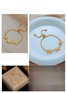 Detail of adjustable gold butterfly chain bracelet with sandblasted zircon pendants