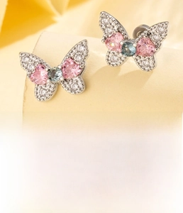 Detail of butterfly ear stud with pink heart zircon and silver titanium steel post