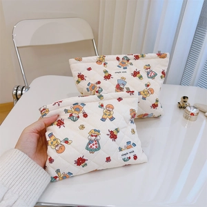 Close-up of quilted floral cosmetic bags in two sizes featuring a simple wish label
