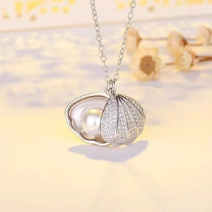 Elegant shell pearl pendant necklace in silver with sparkling crystals on a fine chain