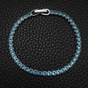 Macro detail of sparkling light blue cubic zirconia tennis bracelet with silver plating