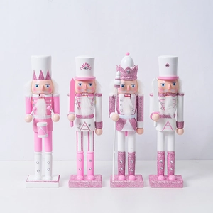 Group shot of four pink and white wooden nutcrackers with festive glitter and rhinestones