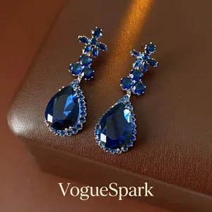 Deep blue water drop earrings with floral zircon cluster in a luxury jewelry gift box