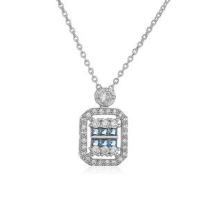 Macro shot of a silver necklace with a rectangular blue gemstone and white zircon stones