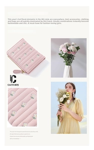 Close-up of pink PU leather wallet featuring detailed daisy floral embroidery and zipper