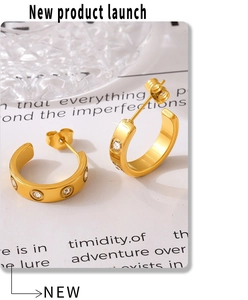 Detail of 18K gold plated C-shape hoop earrings with five sparkling cubic zirconia stones
