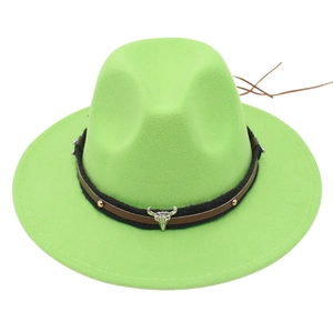 Detail of green felt hat featuring a vintage bull skull metal ornament and studs