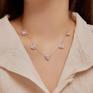 S925 sterling silver collar necklace with five zirconia-studded heart charms on a model
