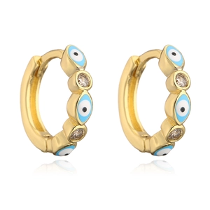 Detail of 18K gold-plated hoop earrings with blue evil eye charms and zircon accents
