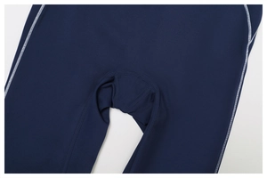 Detailed close-up of high-density contrast flatlock stitching on navy yoga pants