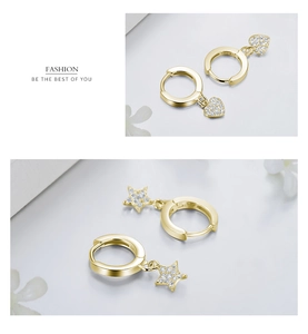 Close-up of gold S925 sterling silver hoop earrings with sparkling star and heart charms