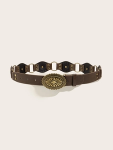 Detail of vintage brown PU leather belt with bronze oval carved buckle and metal rings